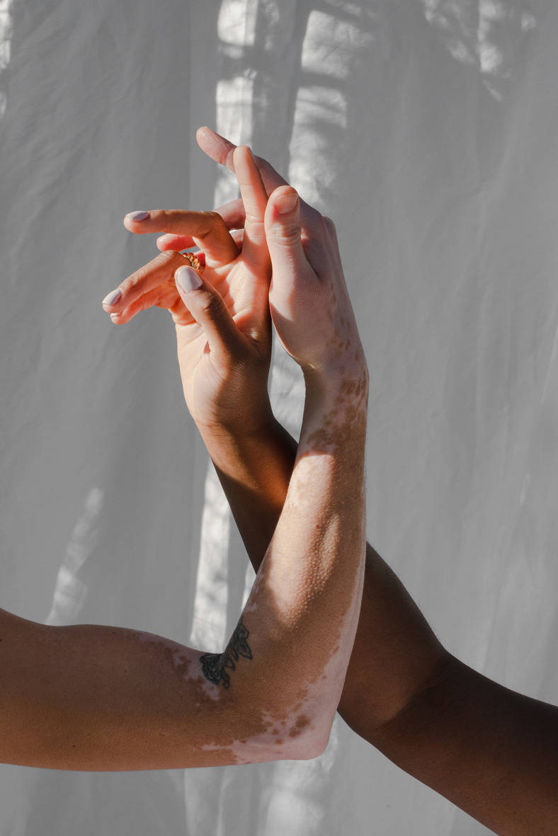 Hands Entwined with White Cloth Background